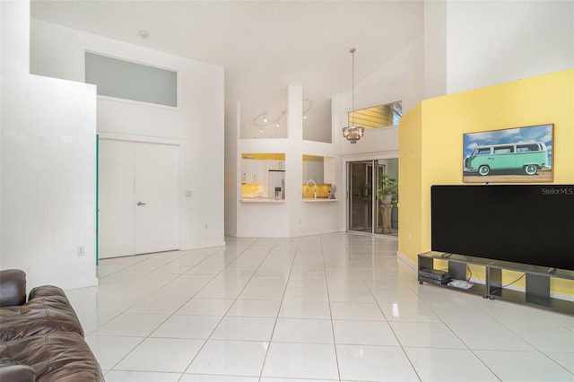 7833 Ontario Street Cir, Sarasota, FL 34243 - living room with high vaulted ceiling, tile patterned flooring, and baseboards
