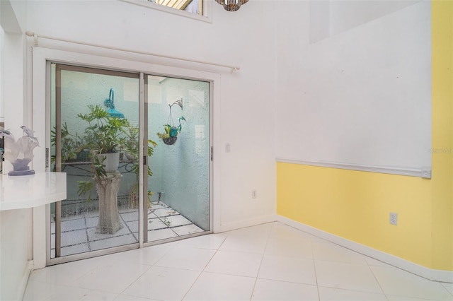 7833 Ontario Street Cir, Sarasota, FL 34243 - interior space featuring baseboards, a chandelier, and tile patterned floors