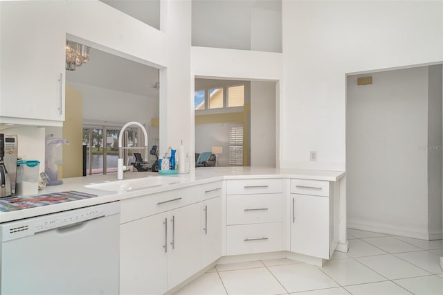 7833 Ontario Street Cir, Sarasota, FL 34243 - kitchen with dishwasher, a sink, light tile patterned floors, light countertops, and a high ceiling