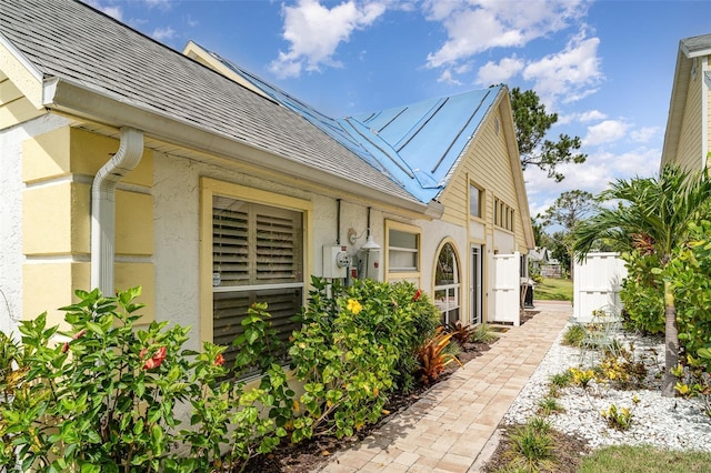 7833 Ontario Street Cir, Sarasota, FL 34243 - property entrance with stucco siding and roof with shingles