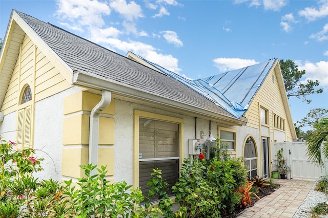 7833 Ontario Street Cir, Sarasota, FL 34243 - view of home's exterior with stucco siding and a shingled roof