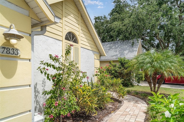 7833 Ontario Street Cir, Sarasota, FL 34243 - view of property exterior with a shingled roof and stucco siding