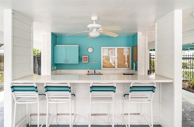 7833 Ontario Street Cir, Sarasota, FL 34243 - kitchen featuring a ceiling fan and tile countertops