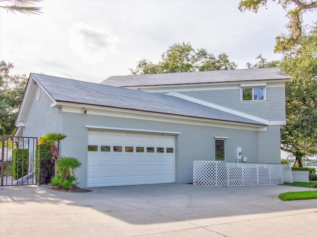 504 Riverside Dr Unit 504, Tarpon Springs, FL 34689 - view of side of home with brick siding, driveway, and a garage
