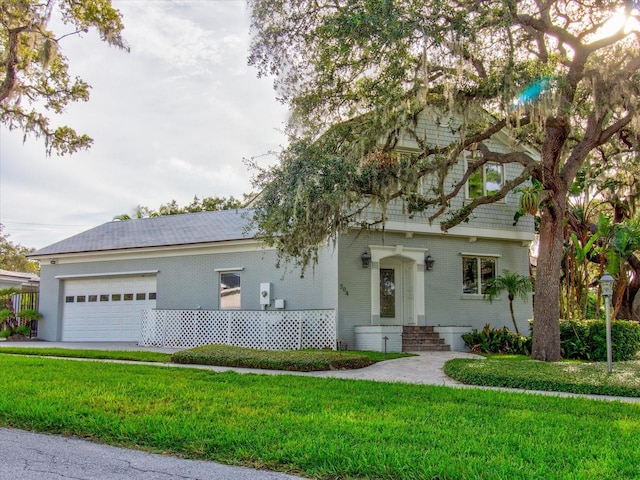 504 Riverside Dr Unit 504, Tarpon Springs, FL 34689 - view of front of property featuring brick siding, an attached garage, and a front yard