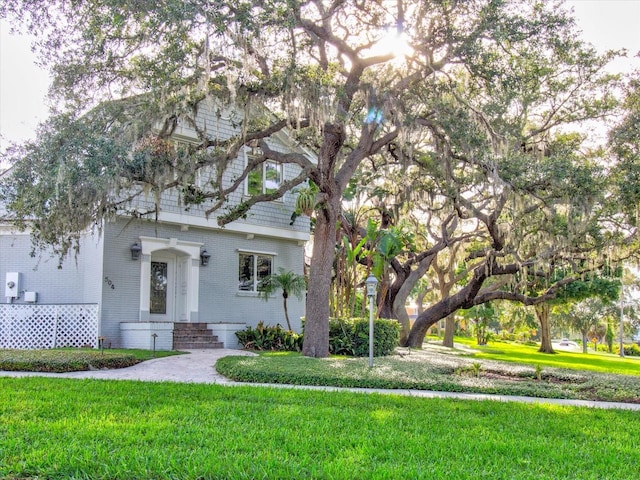 504 Riverside Dr Unit 504, Tarpon Springs, FL 34689 - view of front facade with brick siding, a front yard, and entry steps
