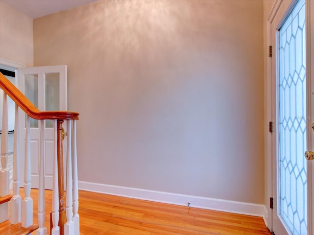 504 Riverside Dr Unit 504, Tarpon Springs, FL 34689 - entrance foyer with baseboards, light wood-style floors, stairway, and plenty of natural light