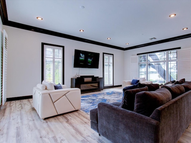 504 Riverside Dr Unit 504, Tarpon Springs, FL 34689 - living area with crown molding, baseboards, light wood-style flooring, a fireplace, and recessed lighting