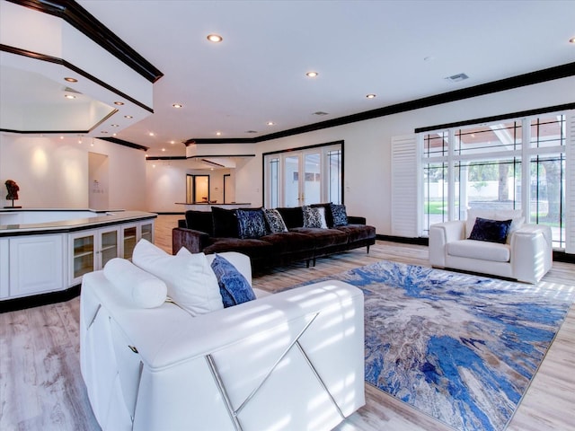 504 Riverside Dr Unit 504, Tarpon Springs, FL 34689 - living area featuring ornamental molding, light wood-style flooring, and recessed lighting