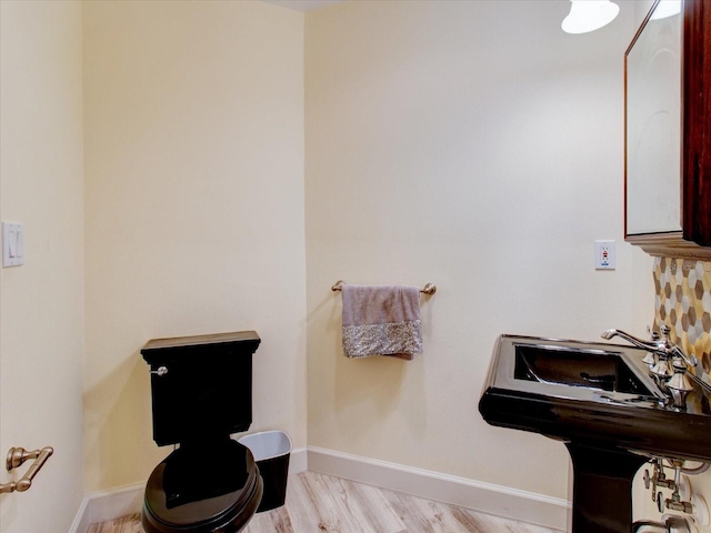 504 Riverside Dr Unit 504, Tarpon Springs, FL 34689 - half bathroom with baseboards, toilet, and wood finished floors