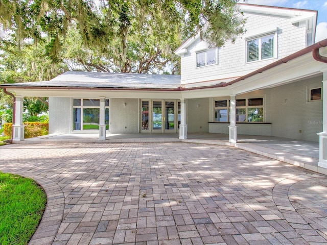 504 Riverside Dr Unit 504, Tarpon Springs, FL 34689 - back of house featuring brick siding