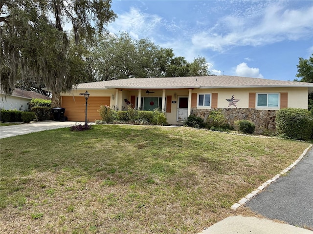560 W Milkweed Loop, Beverly Hills, FL 34465 - ranch-style house with an attached garage, concrete driveway, a front lawn, stucco siding, and stone siding