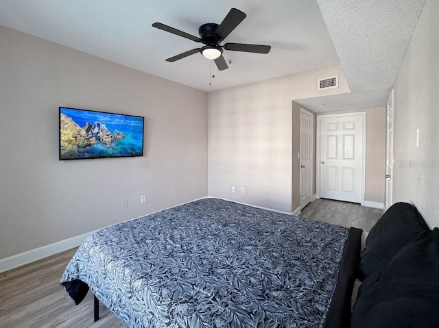 202 E S St Unit 5050, Orlando, FL 32801 - bedroom featuring wood finished floors, baseboards, and ceiling fan