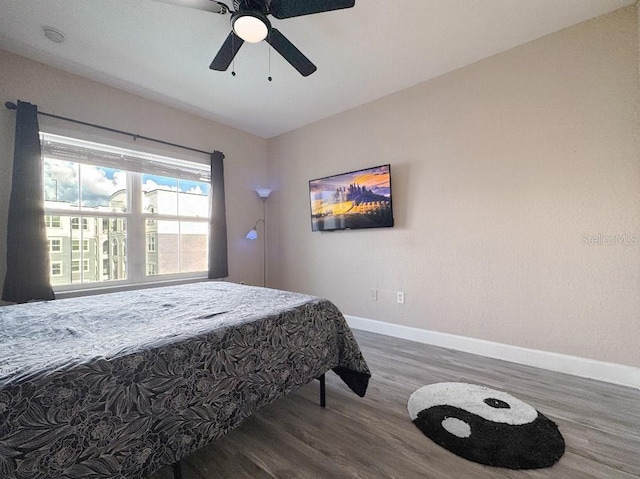 202 E S St Unit 5050, Orlando, FL 32801 - bedroom featuring wood finished floors, baseboards, and a ceiling fan