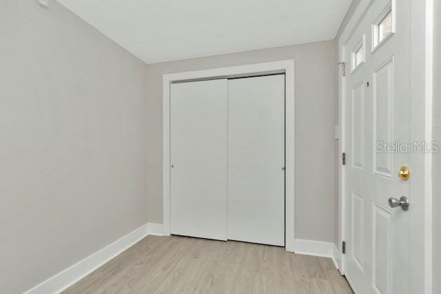 243 45th St N, Saint Petersburg, FL 33713 - unfurnished bedroom featuring light wood-style floors, baseboards, and a closet