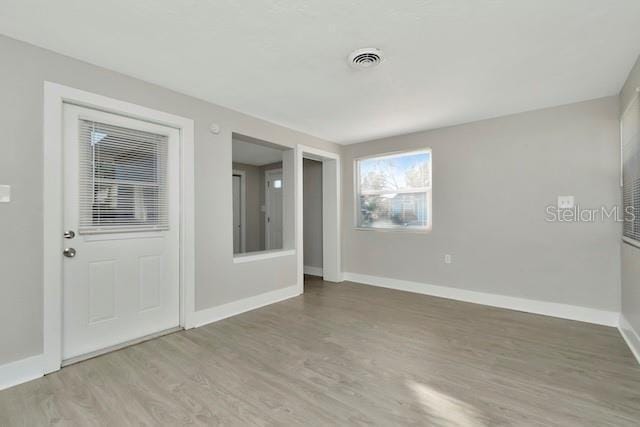243 45th St N, Saint Petersburg, FL 33713 - empty room featuring wood finished floors and baseboards