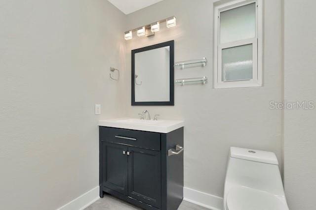 243 45th St N, Saint Petersburg, FL 33713 - bathroom with baseboards, vanity, and toilet