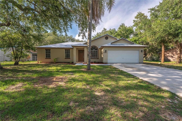 4032 Albany Rd, Labelle, FL 33935 - ranch-style house featuring a garage, stucco siding, concrete driveway, a front yard, and metal roof