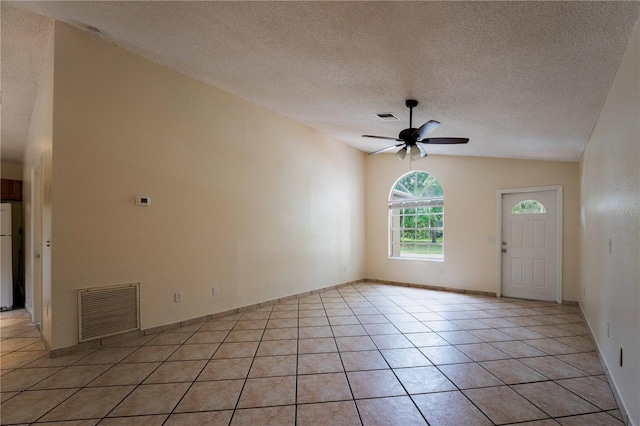 4032 Albany Rd, Labelle, FL 33935 - unfurnished living room with a ceiling fan, a textured ceiling, vaulted ceiling, light tile patterned floors, and baseboards