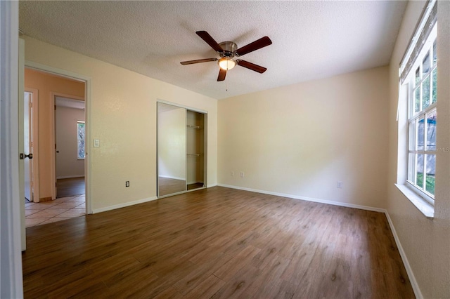 4032 Albany Rd, Labelle, FL 33935 - unfurnished bedroom featuring wood finished floors, a closet, a textured ceiling, baseboards, and ceiling fan