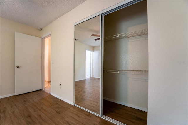 4032 Albany Rd, Labelle, FL 33935 - unfurnished bedroom with wood finished floors, a textured ceiling, a closet, and baseboards