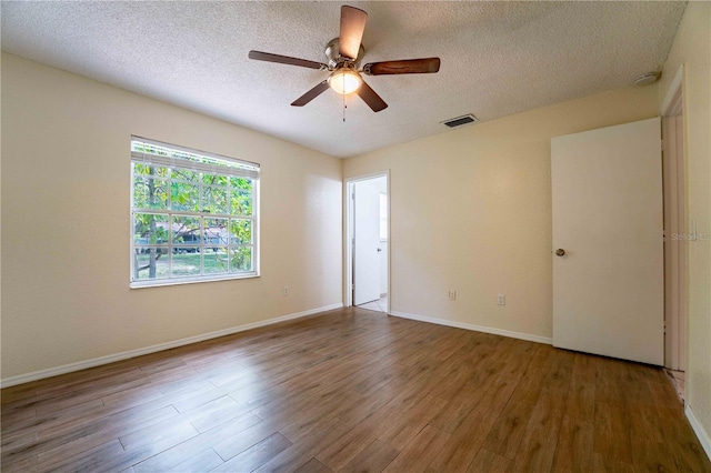 4032 Albany Rd, Labelle, FL 33935 - empty room featuring a textured ceiling, wood finished floors, ceiling fan, and baseboards