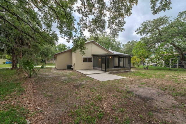 4032 Albany Rd, Labelle, FL 33935 - rear view of property with a sunroom, central AC unit, stucco siding, a patio area, and a yard