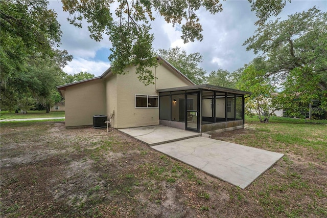 4032 Albany Rd, Labelle, FL 33935 - rear view of house featuring a sunroom, stucco siding, a patio, central AC, and a lawn