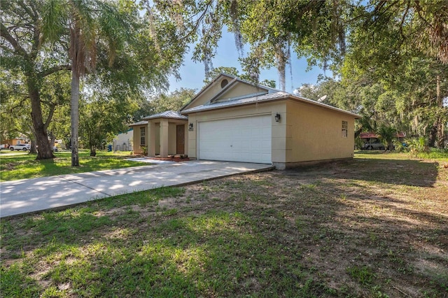 4032 Albany Rd, Labelle, FL 33935 - view of front of property featuring driveway, an attached garage, metal roof, and a front yard