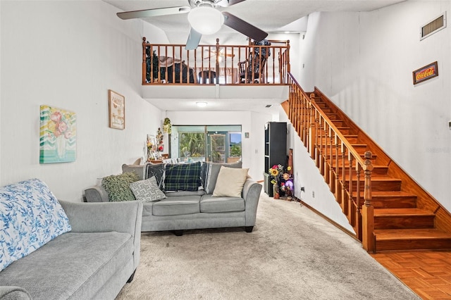 940 Fenton Ln Unit 7, Lakeland, FL 33809 - living room with a ceiling fan, stairs, a towering ceiling, and carpet flooring