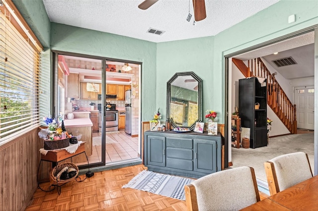940 Fenton Ln Unit 7, Lakeland, FL 33809 - interior space featuring stairs, a ceiling fan, a textured ceiling, and wood walls
