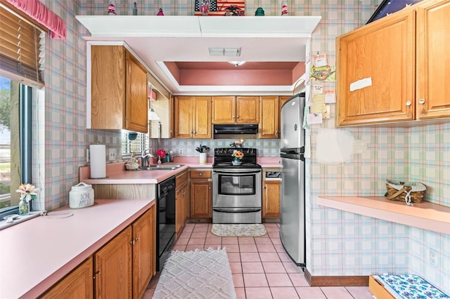 940 Fenton Ln Unit 7, Lakeland, FL 33809 - kitchen with stainless steel appliances, ventilation hood, a sink, light countertops, and light tile patterned flooring