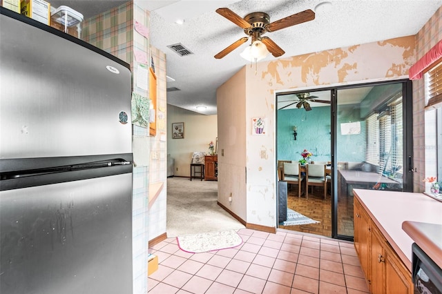 940 Fenton Ln Unit 7, Lakeland, FL 33809 - kitchen featuring freestanding refrigerator, wallpapered walls, ceiling fan, dishwasher, and brown cabinetry