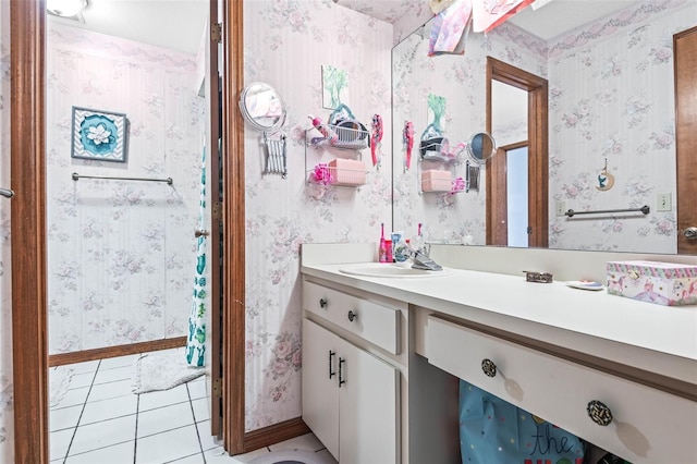 940 Fenton Ln Unit 7, Lakeland, FL 33809 - bathroom with wallpapered walls, vanity, tile patterned flooring, and baseboards