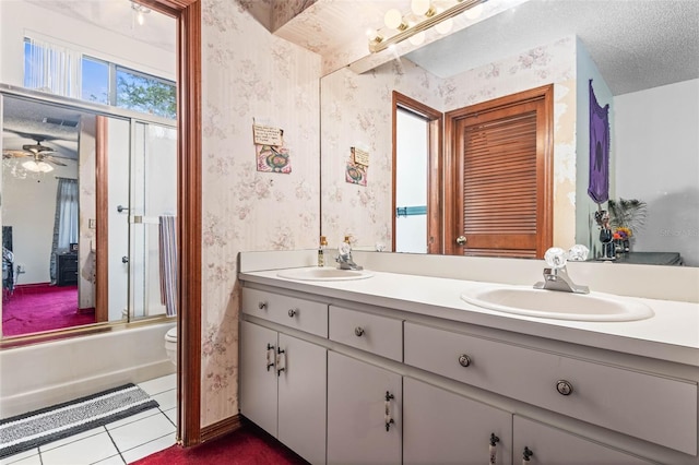 940 Fenton Ln Unit 7, Lakeland, FL 33809 - bathroom featuring wallpapered walls, double vanity, tile patterned flooring, enclosed tub / shower combo, and ceiling fan