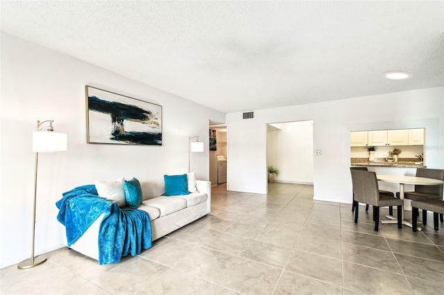 1109 Pine Ridge Cir W Unit C1, Tarpon Springs, FL 34688 - living area featuring a textured ceiling and light tile patterned floors