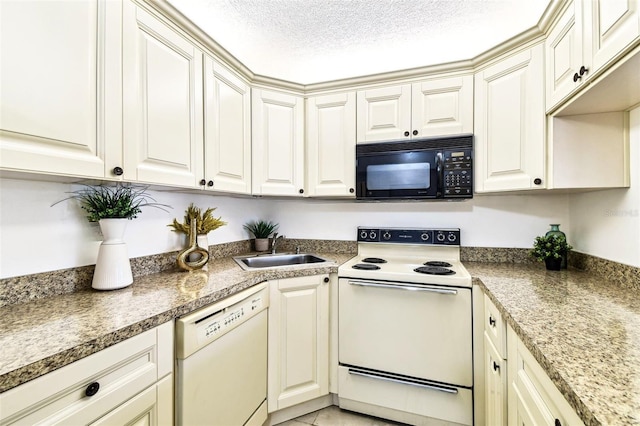 1109 Pine Ridge Cir W Unit C1, Tarpon Springs, FL 34688 - kitchen featuring white appliances, a sink, and a textured ceiling