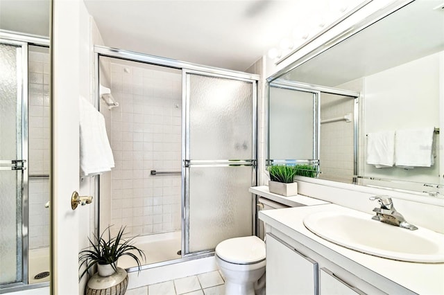 1109 Pine Ridge Cir W Unit C1, Tarpon Springs, FL 34688 - bathroom featuring vanity, a shower stall, toilet, and tile patterned floors