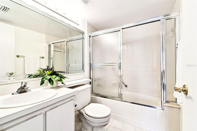 1109 Pine Ridge Cir W Unit C1, Tarpon Springs, FL 34688 - bathroom featuring vanity, enclosed tub / shower combo, toilet, and tile patterned floors