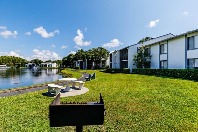 1109 Pine Ridge Cir W Unit C1, Tarpon Springs, FL 34688 - surrounding community featuring a water view and a yard