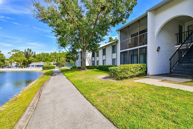 1109 Pine Ridge Cir W Unit C1, Tarpon Springs, FL 34688 - view of property's community with a lawn, stairs, and a water view