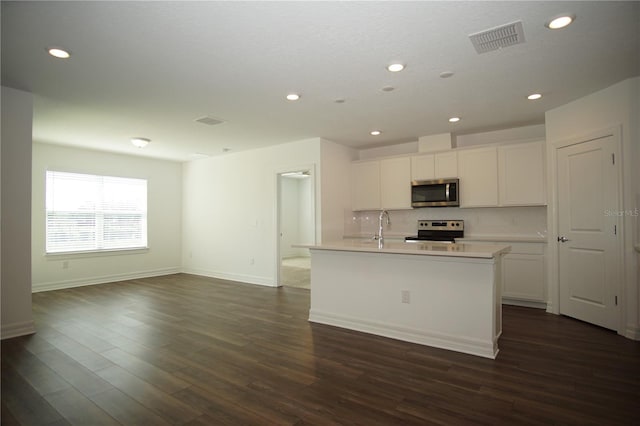 9512 Summers Cay Cir, Thonotosassa, FL 33592 - kitchen featuring stainless steel appliances, recessed lighting, white cabinetry, decorative backsplash, and a kitchen island with sink
