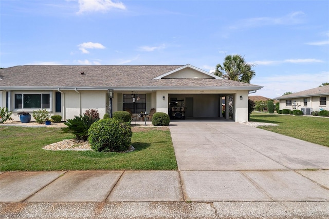 1633 Bentwood Dr, Sun City Center, FL 33573 - ranch-style home with concrete driveway, a front lawn, stucco siding, and a shingled roof