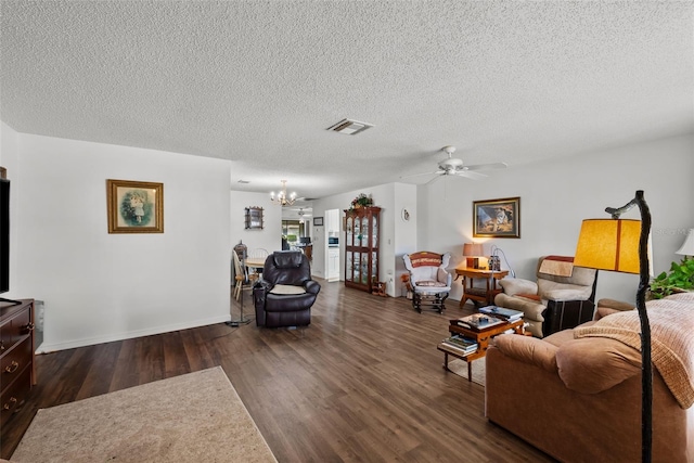 1633 Bentwood Dr, Sun City Center, FL 33573 - living area with dark wood finished floors, a chandelier, a textured ceiling, a ceiling fan, and baseboards