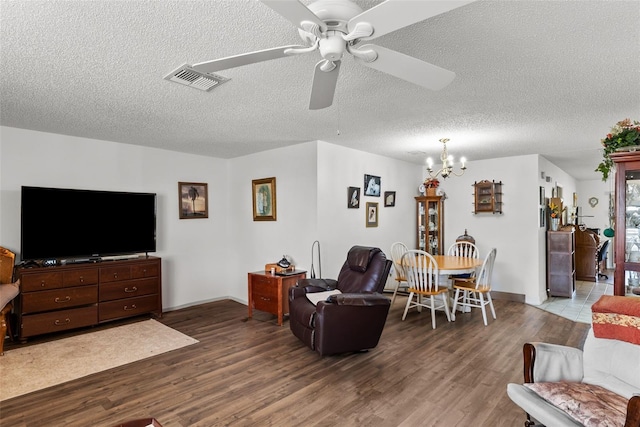 1633 Bentwood Dr, Sun City Center, FL 33573 - living room featuring wood finished floors, a ceiling fan, a chandelier, a textured ceiling, and baseboards
