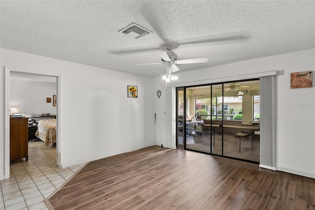 1633 Bentwood Dr, Sun City Center, FL 33573 - unfurnished room featuring a ceiling fan, a textured ceiling, and light wood finished floors