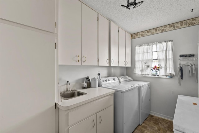 1633 Bentwood Dr, Sun City Center, FL 33573 - laundry area featuring cabinet space, independent washer and dryer, a textured ceiling, and baseboards