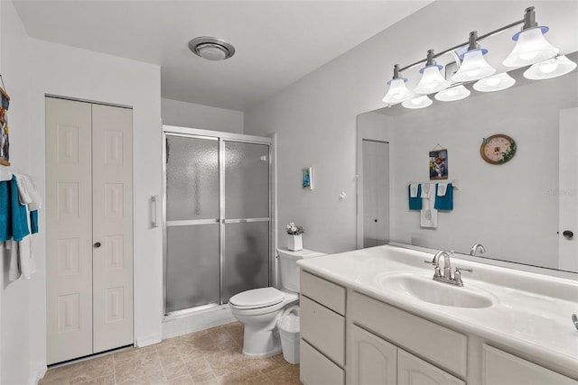 1633 Bentwood Dr, Sun City Center, FL 33573 - bathroom featuring a closet, vanity, a shower stall, and toilet