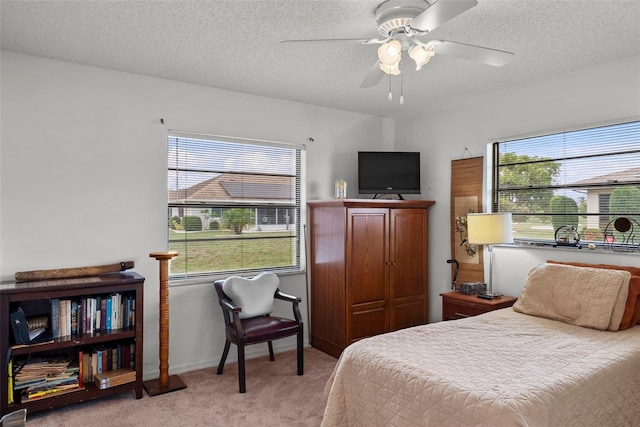 1633 Bentwood Dr, Sun City Center, FL 33573 - bedroom featuring carpet floors, a textured ceiling, a ceiling fan, and baseboards