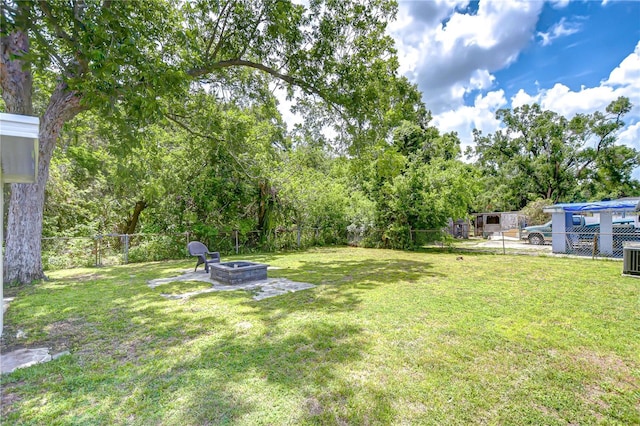 6004 S 82nd St, Tampa, FL 33619 - view of yard featuring a fire pit and central AC unit